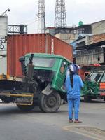 West Java, Indonesia on July 2022. A trailer truck had an accident while making a U-turn photo