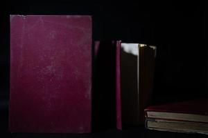 a collection of old books that are weathered in piles. vintage and retro theme backgrounds photo