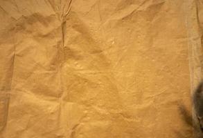 golden old paper with torn and crumpled texture for background photo