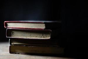 a collection of old books that are weathered in piles. vintage and retro theme backgrounds photo