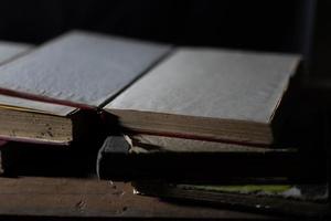 a collection of old books that are weathered in piles. vintage and retro theme backgrounds photo