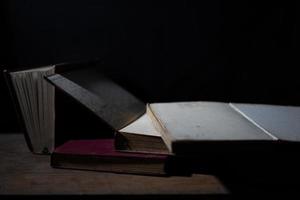 a collection of old books that are weathered in piles. vintage and retro theme backgrounds photo