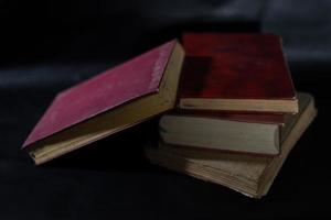 a collection of old books that are weathered in piles. vintage and retro theme backgrounds photo