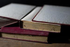 a collection of old books that are weathered in piles. vintage and retro theme backgrounds photo