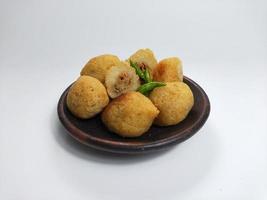 Comro or Combro is a typical Sundanese fried food, West Java, Indonesia. Comro or Combro is made from grated cassava which is shaped round or oval and filled with chili oncom and then fried. photo