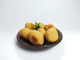 Comro or Combro is a typical Sundanese fried food, West Java, Indonesia. Comro or Combro is made from grated cassava which is shaped round or oval and filled with chili oncom and then fried. photo