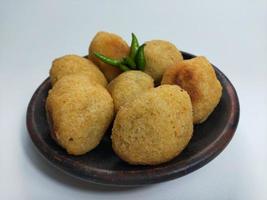 Comro or Combro is a typical Sundanese fried food, West Java, Indonesia. Comro or Combro is made from grated cassava which is shaped round or oval and filled with chili oncom and then fried. photo