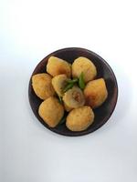 Comro or Combro is a typical Sundanese fried food, West Java, Indonesia. Comro or Combro is made from grated cassava which is shaped round or oval and filled with chili oncom and then fried. photo