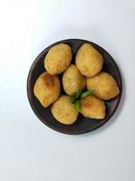 Comro or Combro is a typical Sundanese fried food, West Java, Indonesia. Comro or Combro is made from grated cassava which is shaped round or oval and filled with chili oncom and then fried. photo