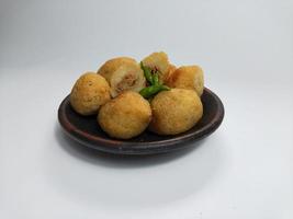 Comro or Combro is a typical Sundanese fried food, West Java, Indonesia. Comro or Combro is made from grated cassava which is shaped round or oval and filled with chili oncom and then fried. photo