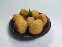 Comro or Combro is a typical Sundanese fried food, West Java, Indonesia. Comro or Combro is made from grated cassava which is shaped round or oval and filled with chili oncom and then fried. photo