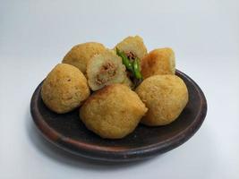 Comro or Combro is a typical Sundanese fried food, West Java, Indonesia. Comro or Combro is made from grated cassava which is shaped round or oval and filled with chili oncom and then fried. photo