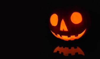 Jack O Lantern lit in the dark for Halloween photo