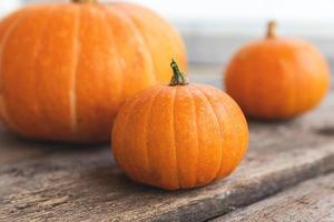 Autumnal Background. Natural autumn fall view pumpkins on wooden background. Inspirational october or september wallpaper. Change of seasons ripe organic food concept, Halloween party Thanksgiving day photo