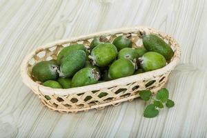 Feijoa on wooden background photo