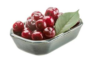 Cherry in a bowl on white background photo