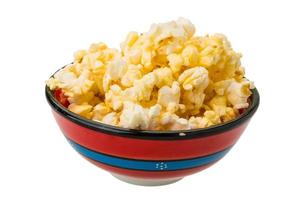 Popcorn in a bowl on white background photo