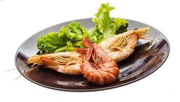 Boiled king prawns on the plate and white background photo