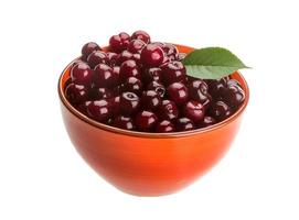 Cherry in a bowl on white background photo