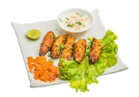 Shish kebab on the plate and white background photo