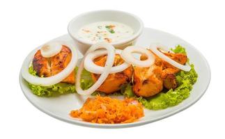 Chicken Tikka on the plate and white background photo