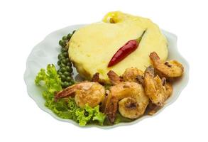 Garlic shrimps with potato on the plate and white background photo