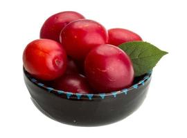 Damson plum in a bowl on white background photo