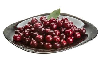 Cherry in the bowl on white background photo