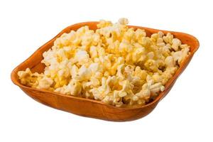 Popcorn in a bowl on white background photo