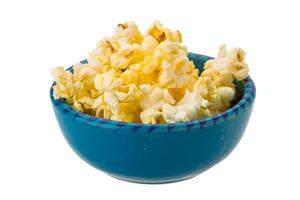 Popcorn in a bowl on white background photo