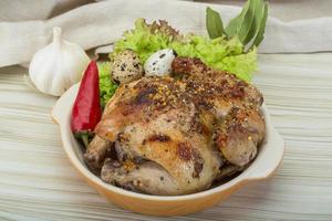 Quail grilled on wooden background photo