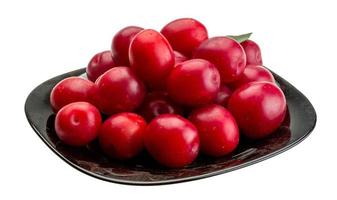 Damson plum on the plate and white background photo