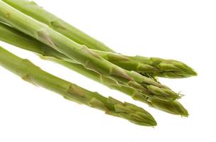 Raw asparagus on white background photo