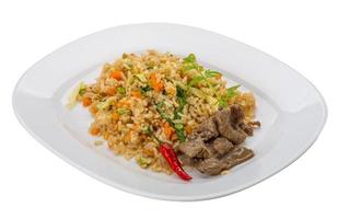 Fried rice with beef on the plate and white background photo