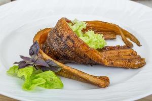 Eel on the plate and wooden background photo