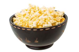 Popcorn in a bowl on white background photo