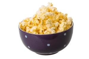 Popcorn in a bowl on white background photo