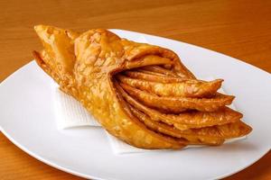 Baklava on the plate and wooden background photo