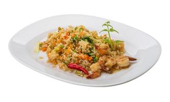 Fried rice with shrimps on the plate and white background photo