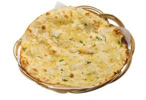 Onion naan in a basket on white background photo