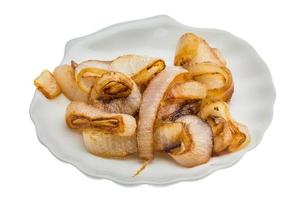 Fried onion on the plate and white background photo