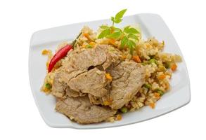 Fried rice with pork on the plate and white background photo