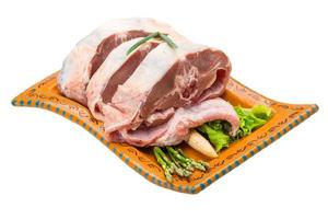 Raw lamb on the plate and white background photo