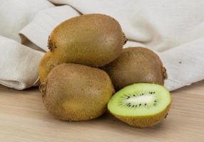 Kiwi fruit on wooden background photo