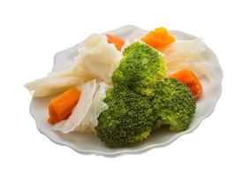 Boiled cabbage and broccoli on the plate and white background photo