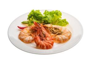 Boiled king prawns on the plate and white background photo