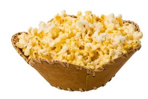 Popcorn in a basket on white background photo