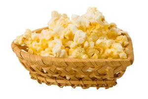 Popcorn in a basket on white background photo