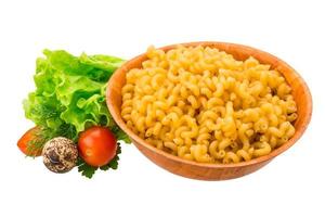 Fusilli pasta in a bowl on white background photo