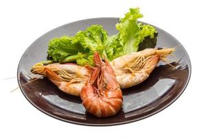 Boiled king prawns on the plate and white background photo